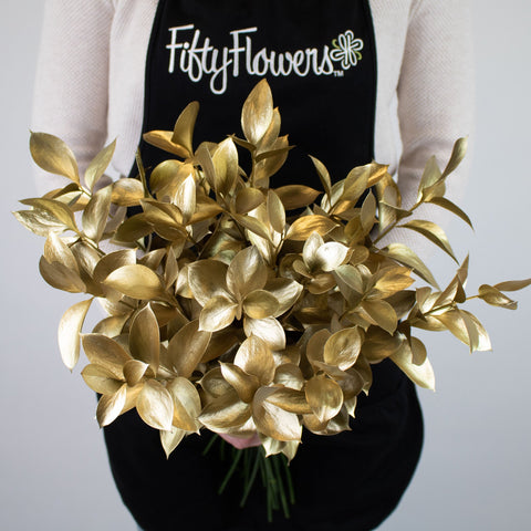 Gold Tinted Ruscus Greenery Bunch in Hand
