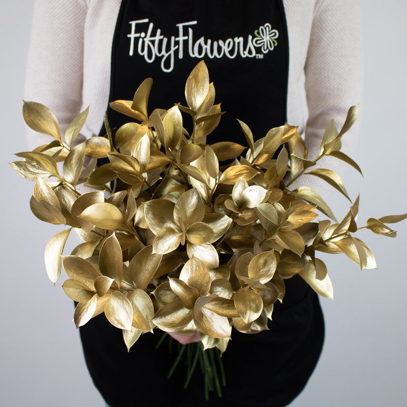 Gold Tinted Ruscus Greenery Bunch in Hand