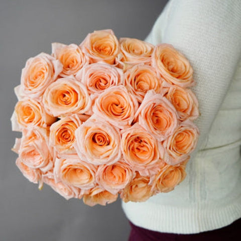 fresh peach and pink tiffany roses in arm