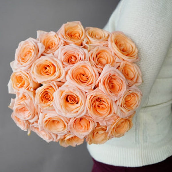 fresh peach and pink tiffany roses in arm