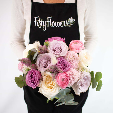 Pink and Purple Flower Centerpiece in Hand