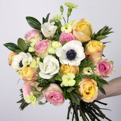 Sunset Valentines Flower Arrangement in a Hand