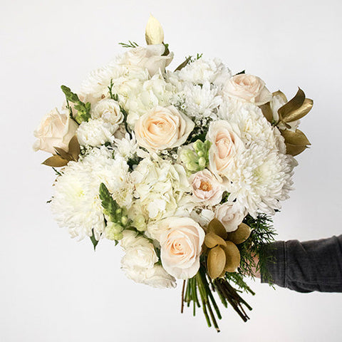 White and Gold Flower Bouquet in Hand